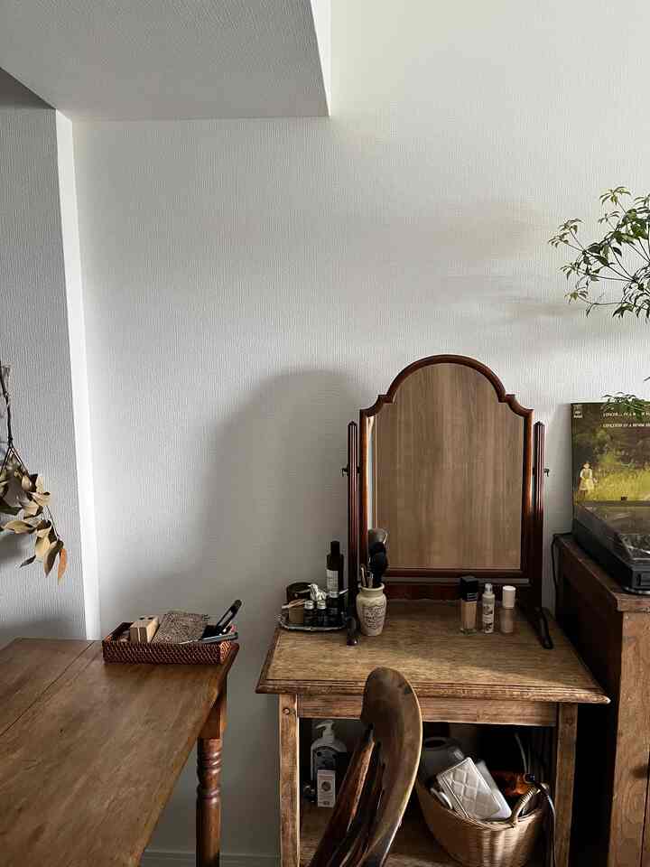 Natural wood tone and beige small room featuring a vanity with mirror and vintage style elements