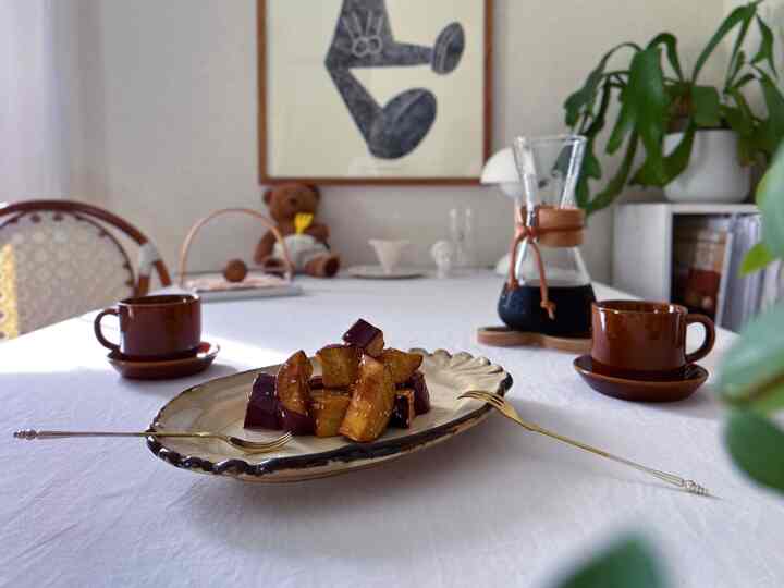 Brown and white toned home cafe dining space featuring artisan pottery and coffee set, creating a cozy cafe-style atmosphere