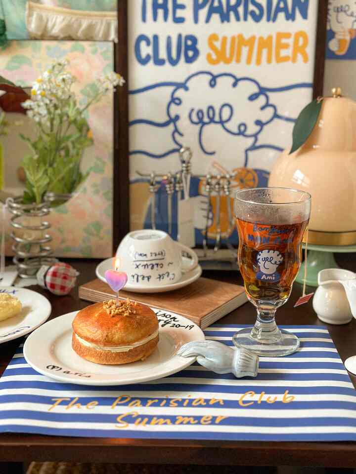 A white and blue toned kitchen table featuring vintage posters and Same.d coffee cup set, cozy home cafe scene with baby context