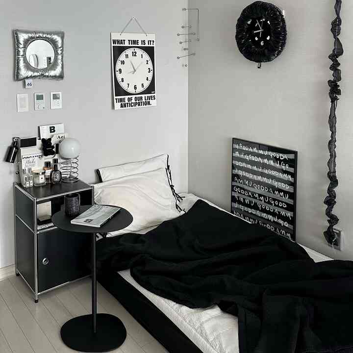 Black and white toned bedroom featuring a modern side table and bed with a sleek atmosphere