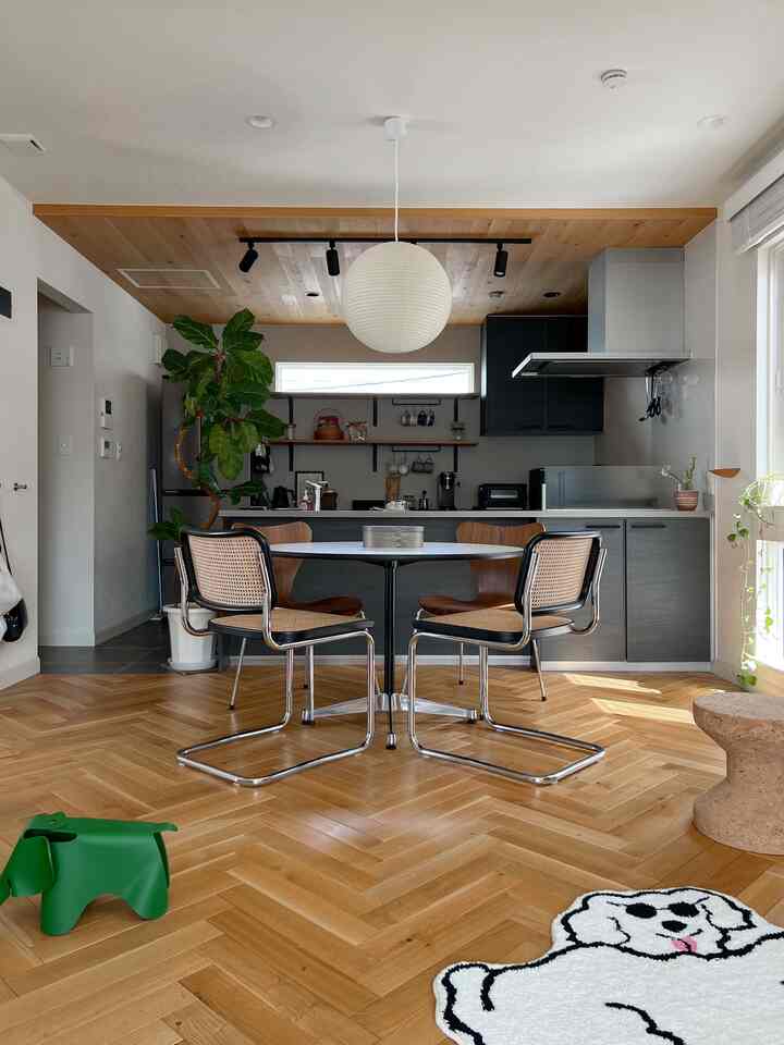 Bright natural tone kitchen and dining room featuring wooden floor and ceiling with a cozy atmosphere