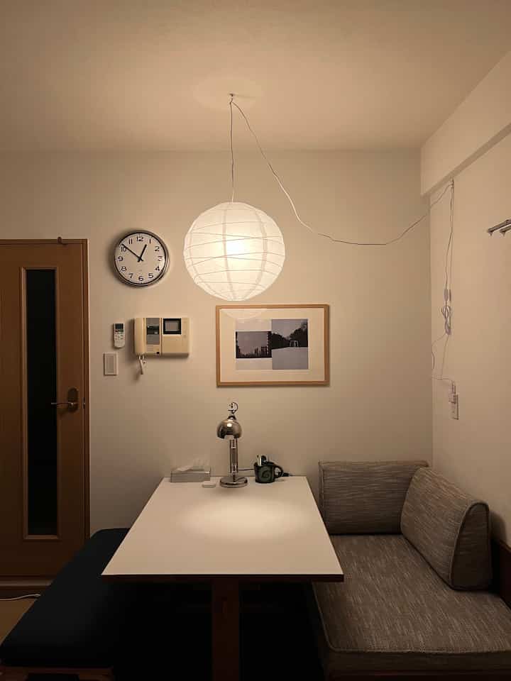 白と木目調の落ち着いたダイニングスペース、ベンチソファと丸いペンダントライトが印象的な雰囲気のあるインテリア