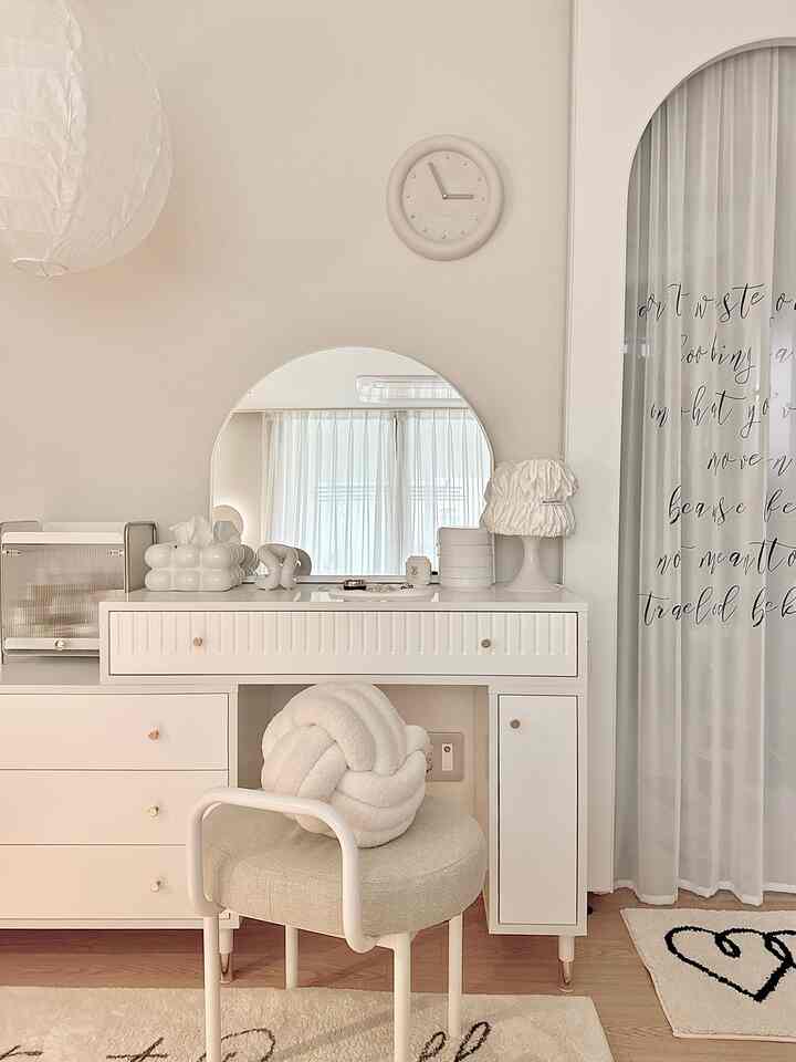 柔らかいホワイトとベージュの色調の寝室、テンバボードの化粧台とアーチ型の鏡が配置された、雰囲気のあるナチュラルなインテリア
