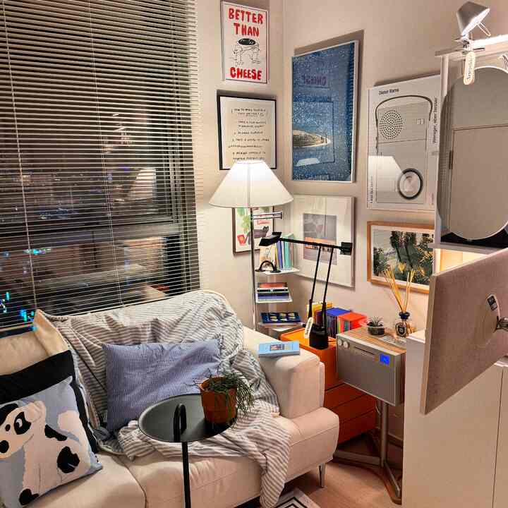 White and black toned living room featuring sofa, side table, floor lamp creating a cozy atmosphere