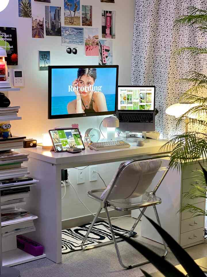 White and black toned studio apartment home office featuring a white desk, string lights and modern minimalist decor