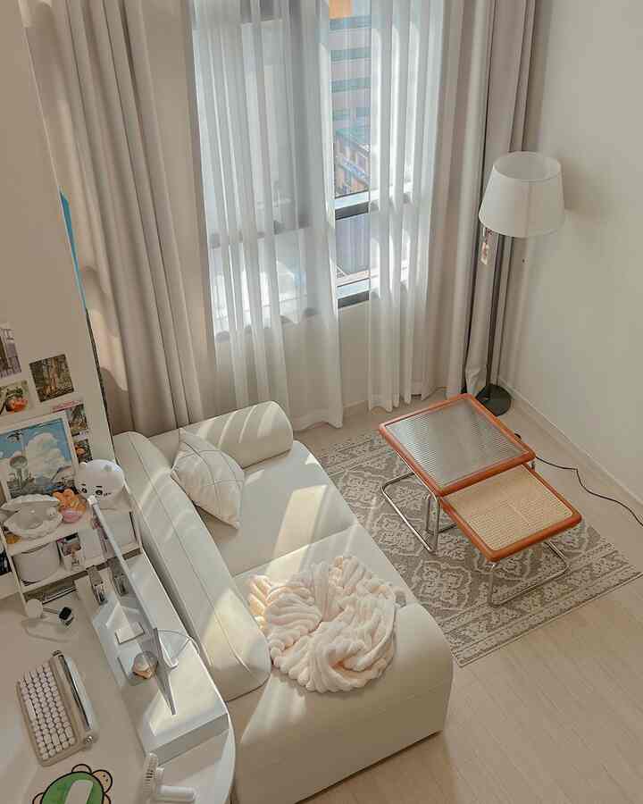 Bright white and beige living room featuring a white sofa, beige rug, side tables with a natural modern atmosphere