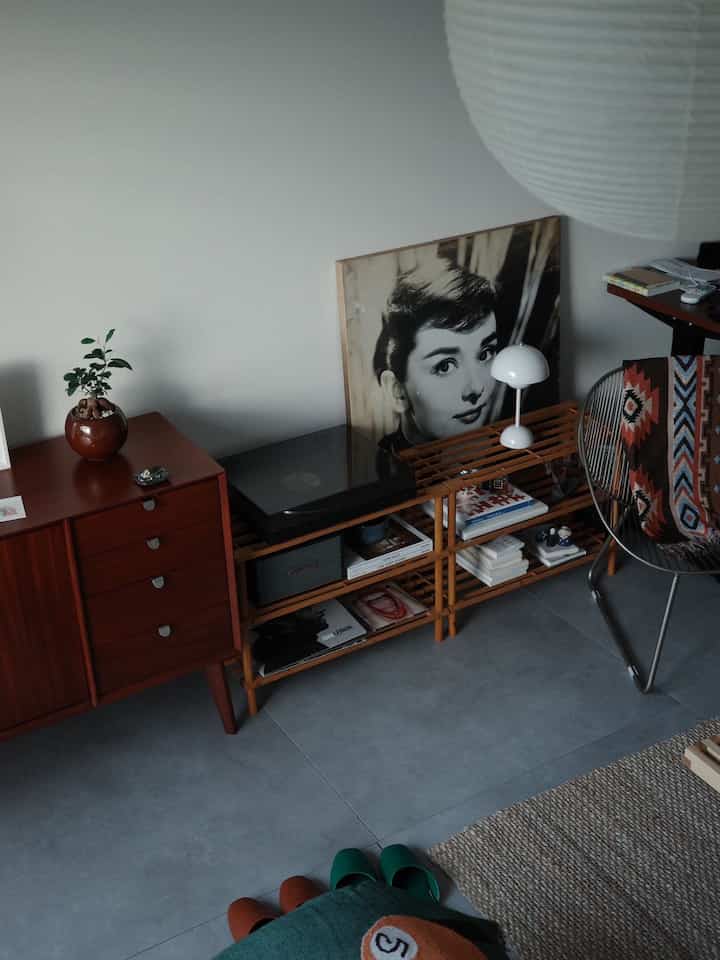 ナチュラルな木目調とシンプルな北欧スタイルのリビング、ヴィンテージ家具とLPプレーヤーが配置された雰囲気のあるインテリア