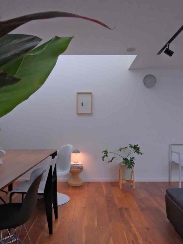 White walls and brown wood flooring in a dining room featuring Nordic and Wa-Modern styles with a simple, natural atmosphere