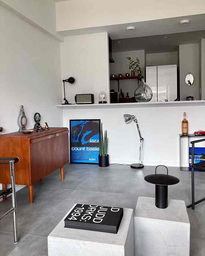 White-walled and gray-floored home office combining industrial and mid-century modern elements