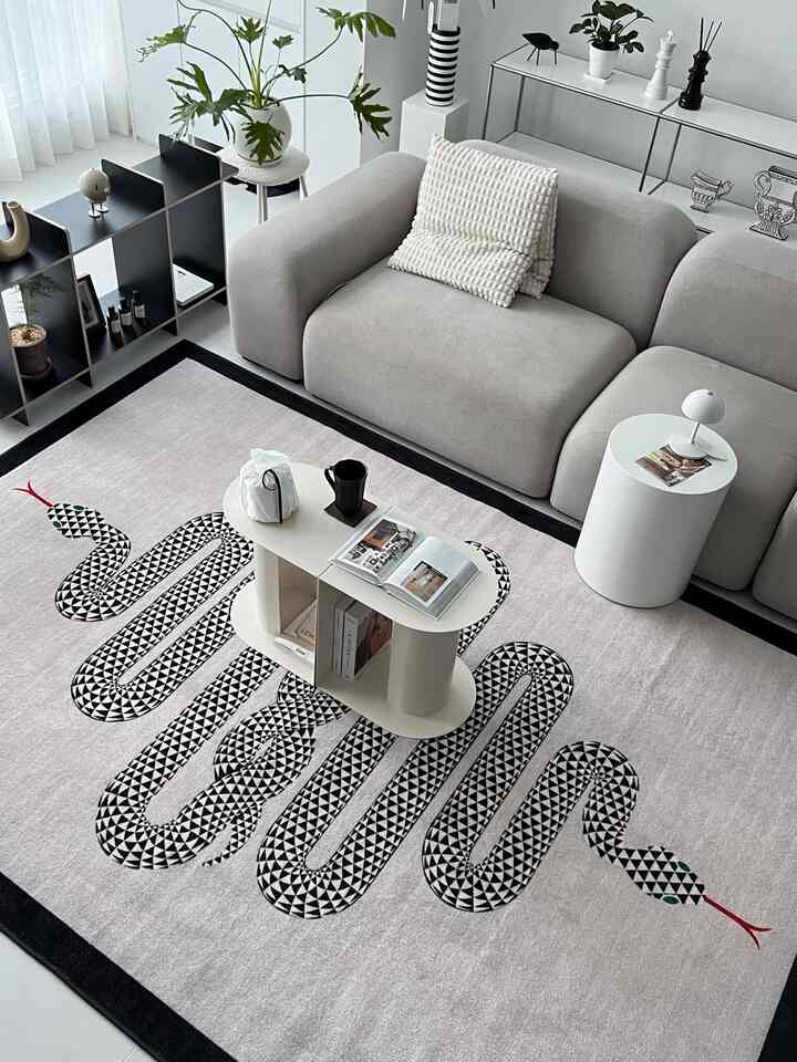 Gray and black toned living room featuring a snake-patterned rug, modern coffee table, and sofa in a natural modern interior