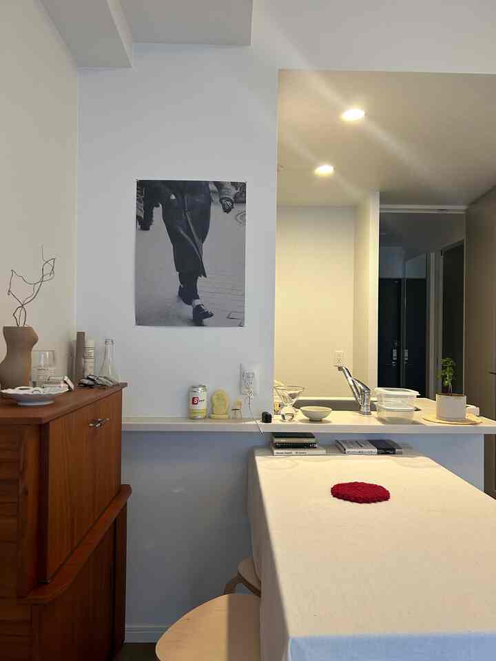Beige tablecloth covered dining room with natural wood tone furniture creating a simple and cozy space