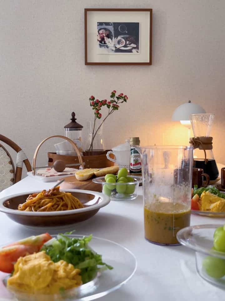 White tablecloth and brown tableware on dining table in kitchen space featuring natural elements and cozy home cafe vibe