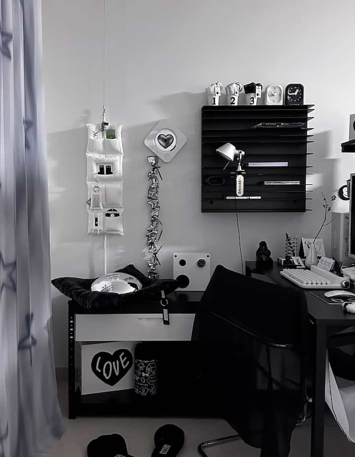 Monotone black and white compact home office featuring black rack and white drawer cabinet in a tidy setup