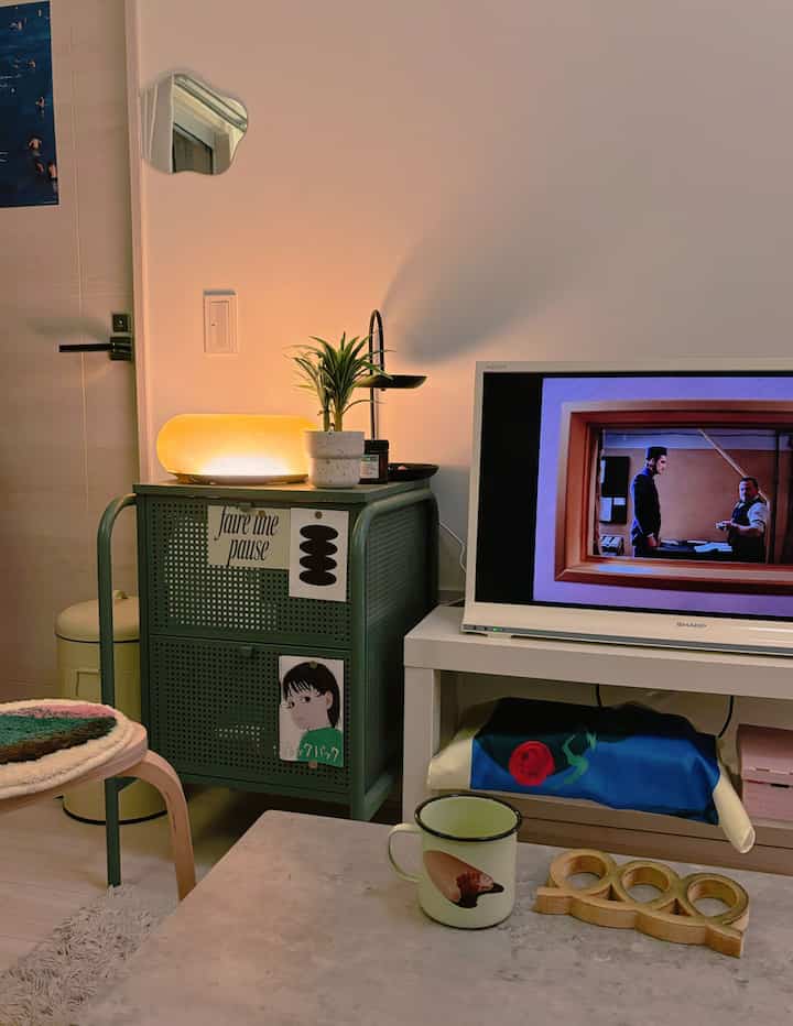 White and green toned living room featuring IKEA furniture and cozy lighting