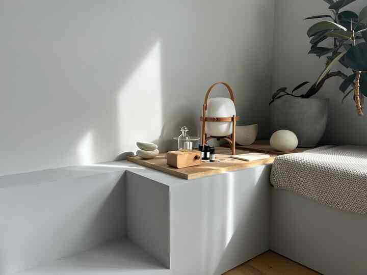 ナチュラルカラーのリビング、木製トレイにディフューザーとオブジェが配置された落ち着いた雰囲気のインテリア