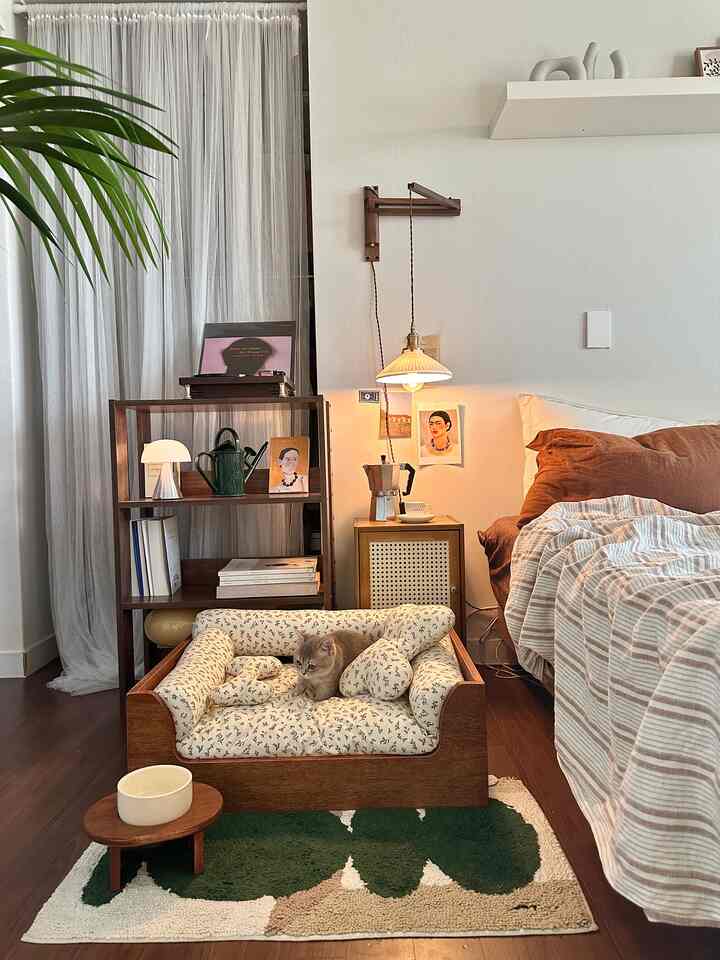 Wood tone natural bedroom featuring a cushioned wooden pet bed with a cat, creating a cozy atmosphere