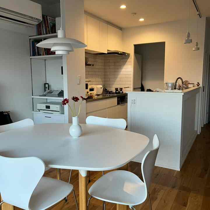 White and wood tone Nordic dining room and kitchen featuring minimalist and simple atmosphere