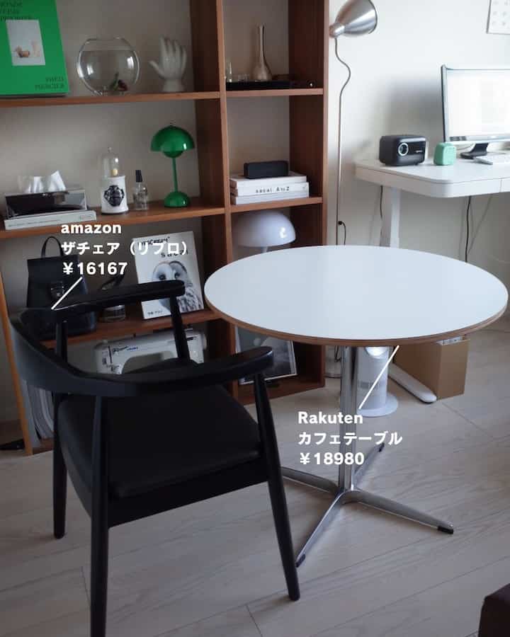 White and wood tone living room for single household with cafe style, featuring round table and black chair in cozy setting