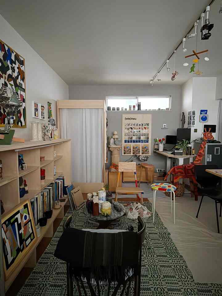 Light-toned 37m² 1LDK home featuring natural wood furniture with a home office and living area setup