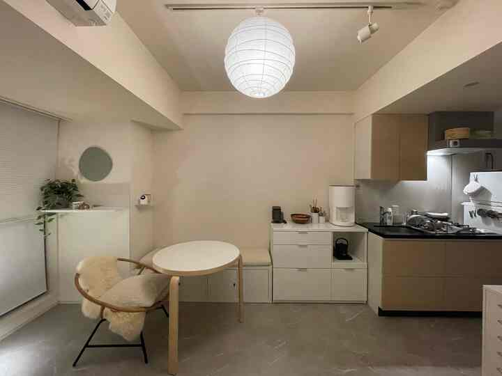Natural modern small kitchen and dining space in white and beige tones, featuring minimalist and cozy design