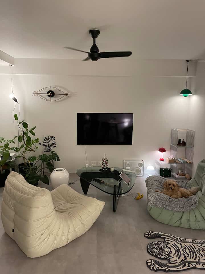 Natural-toned living room with beige and green sofas, featuring a simple modern interior design