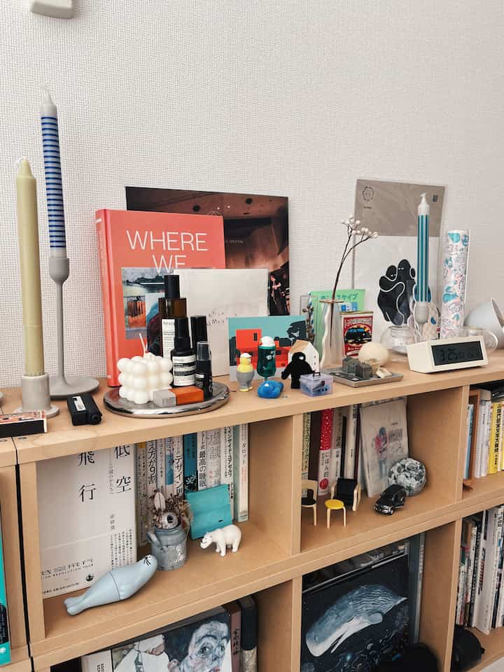 Natural tone bookshelf filled with various objects and books in a neat interior space