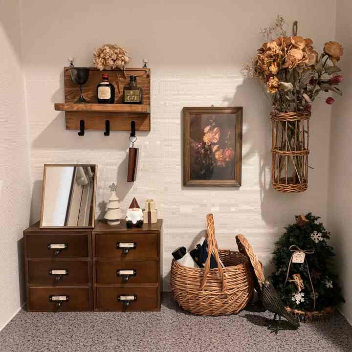 Brown-toned entrance space featuring vintage storage chest and Christmas decorations with a natural atmosphere