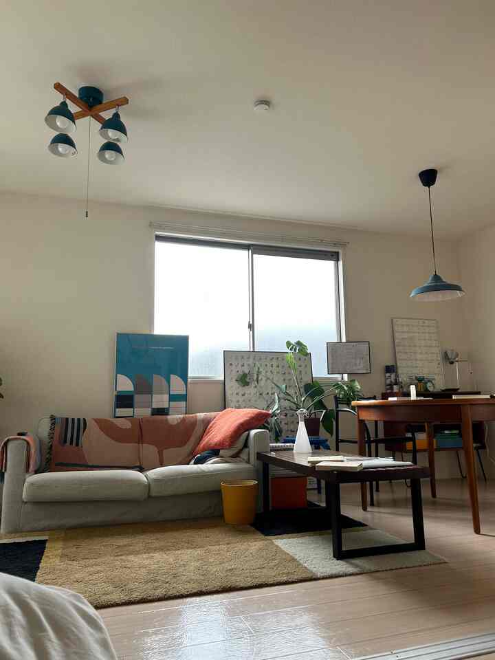 Warm brown and white toned living and dining room featuring sofa and dining table creating a cozy space