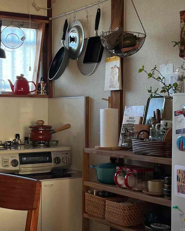 A natural and brown toned kitchen space, featuring wooden shelves and cabinets neatly storing kitchenware, with a cozy atmosphere