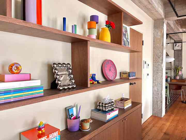 Natural style space with brown wood-tone shelves and white walls featuring storage units