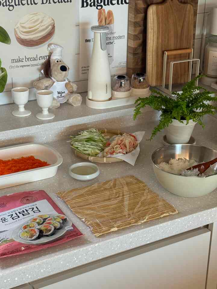 Natural tone kitchen featuring plants, wooden cutting boards, and kitchen utensils with a cozy atmosphere