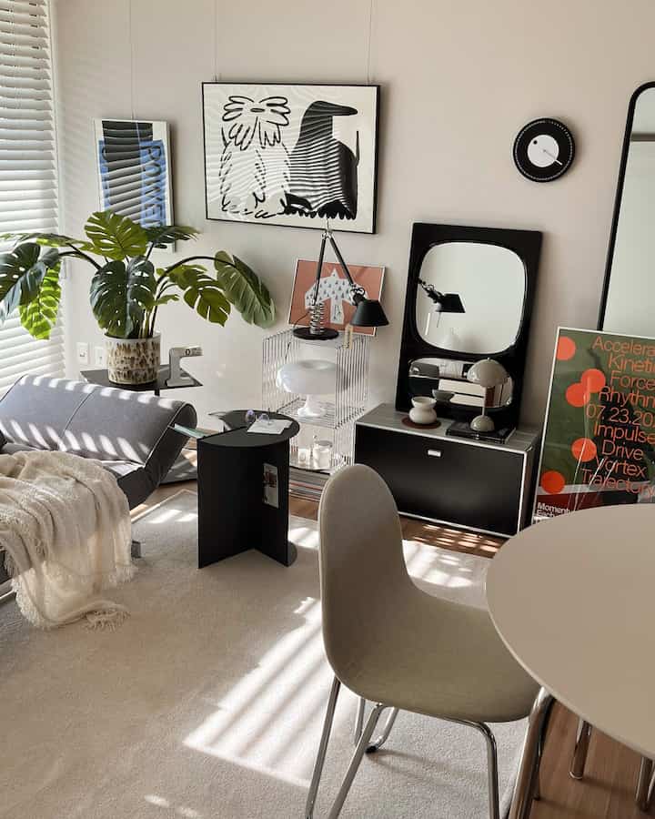 Beige rug and modern Mid-Century furniture arranged in a living room with white walls and a black wall clock creating a harmonious space