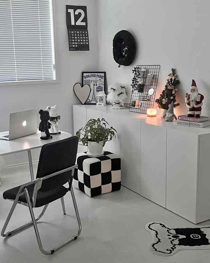 Monotone black and white study featuring minimalist furniture and cozy Christmas decorations