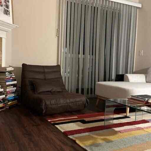 Mid-Century Modern living room with brown leather lounge chair and white sofa, warm and cozy atmosphere