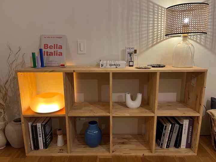 Natural wood tone Nordic-style living room shelf with table lamps arranged for cozy ambiance