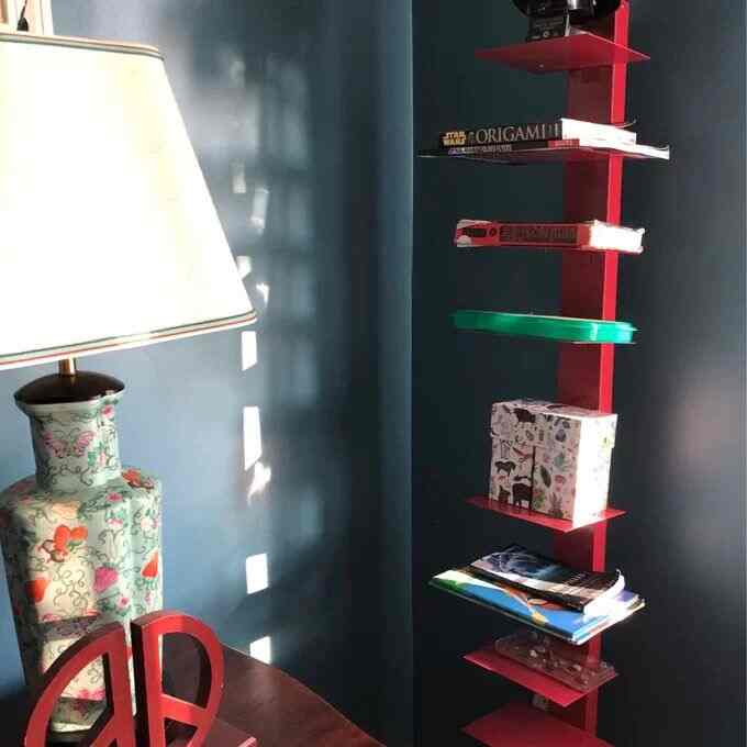 Add a pop of color to the room with this intense red bookstand! 🔴📚 It's bold, vibrant, and perfect for showcasing my favorite reads! #Bookstand #HomeDecor #ModernBookshelf #EclecticDecor #ColorfulInterior #Hermanmillerbookstand #Hermanmillerdupes
