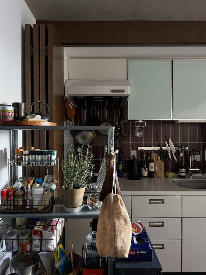 White kitchen space featuring metal shelves and wooden slats in a Mid-Century Modern style interior
