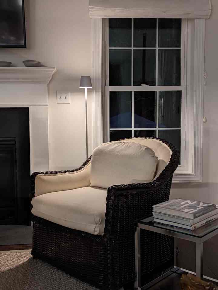 Cozying up in my favorite lounge chair with the perfect moody lamp lighting the way. ✨🛋️ #CozyVibes #MoodLighting #WickerChair #CozyLiving #ModernInterior
