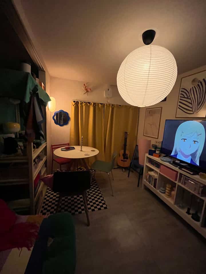 Cozy two-person dining room with yellow curtains and white pendant lighting