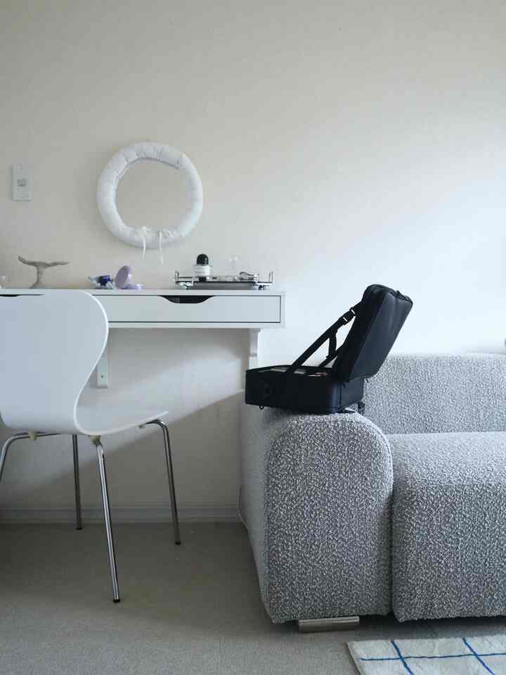 White and gray toned living room featuring modular sofa and white drawer unit creating a simple natural atmosphere