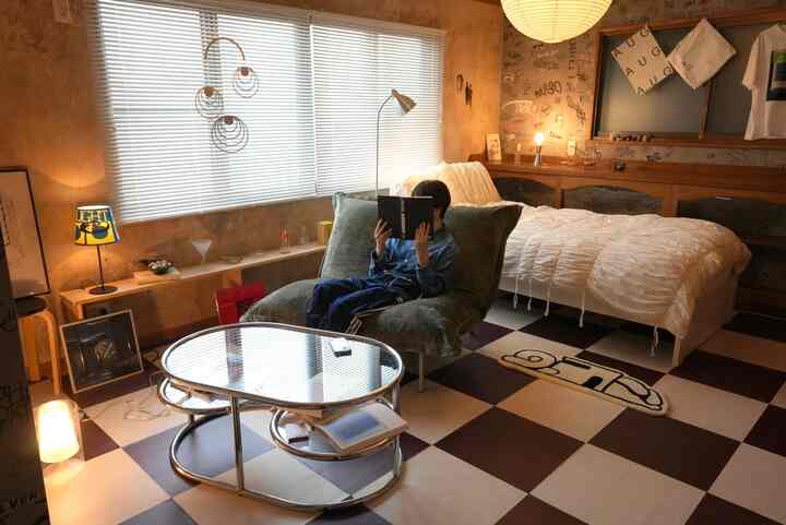 Natural tones and white blend in a bedroom featuring vintage wallpaper and indirect lighting creating a cozy atmosphere