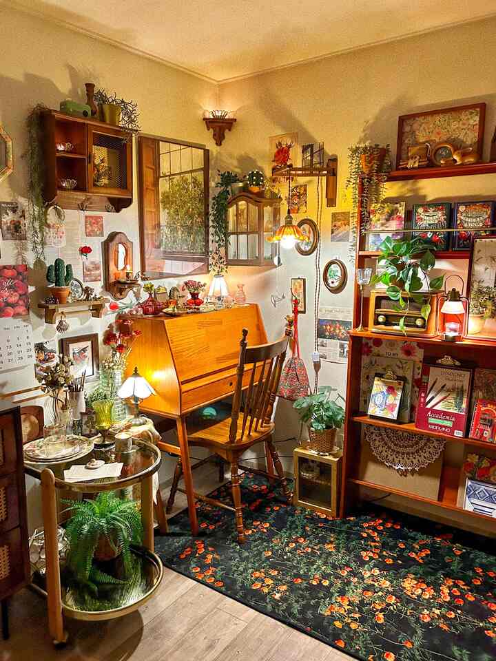 温かみのあるベージュの壁と木製家具が調和したヴィンテージ風のホームオフィス、様々なヴィンテージ小物と植物が配置された居心地の良いワークスペース