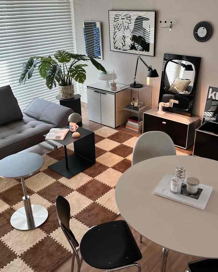 Beige and brown toned living room featuring a plush checkered mat and modern furniture with a cozy atmosphere