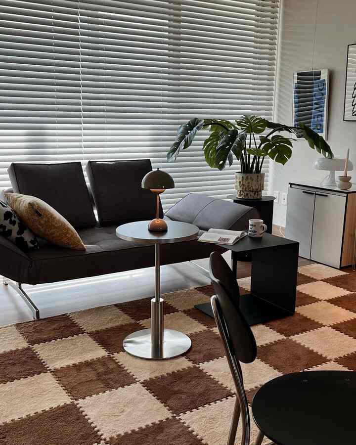 Modern living room with brown and beige checkered rug and gray sofa