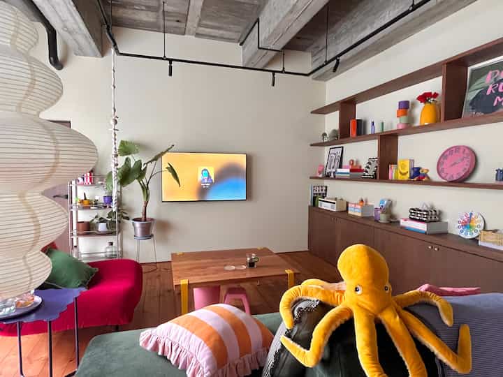 Mid-Century Modern living room with wood tones and yellow accents, featuring various sofas and wall storage for a cozy atmosphere