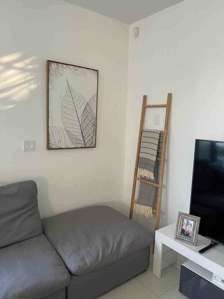 Embracing the beauty of simplicity in my white modern living room. 🕊️✨ A space that feels calm and inviting, perfect for cozy moments and fresh ideas! 🛋️🤍 #ModernHome #WhiteAesthetic #LivingRoomGoals #LadderShelf #MinimalistDecor #SectionalSofa