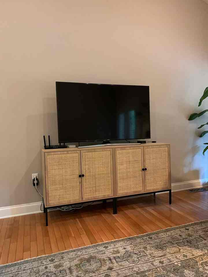 I needed to replace our open shelving media console with something that could be child-proofed. I had considered buying the expensive version of this from one of the big names, but when I found this option for such a great price, I thought it was an even better idea. Now I won’t feel as upset if my toddler causes damage to it, all the while it looks just as good as the expensive ones! From a distance of course, but no one is going up to a media console and knocking on it to determine if it’s solid wood, haha,It took my husband and I probably an hour total to assemble it. The instructions were relatively easy to follow, and there were extra pieces of hardware (which we didn’t need). Everything fit together perfectly, and we didn’t even have one argument during assembly (that’s a testament to how easy it was).Overall I’m extremely pleased with this purchase, and although I don’t expect these pieces to last forever, they are going to serve me well for the next few years I’m sure.

#TVStand #MidCenturyModern #RattanFurniture