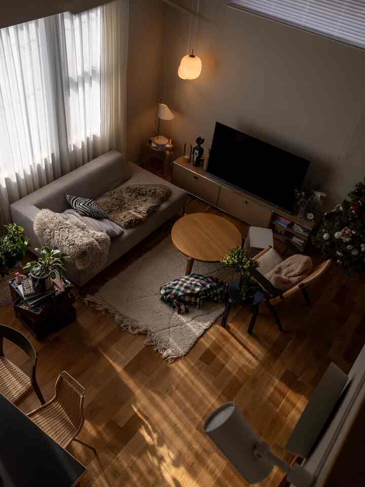 Beige and wood tone living room featuring Mid-Century Modern furniture and a Christmas tree with a warm, cozy atmosphere