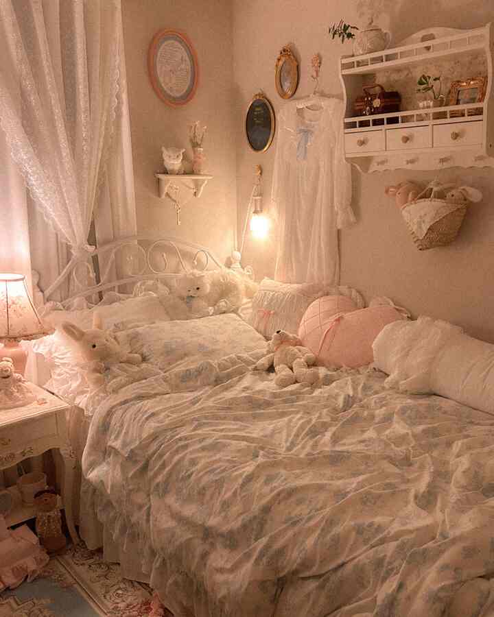 ピンクと白のトーンの寝室、ロマンチックでアンティークな小物と寝具が配置された雰囲気のあるインテリア