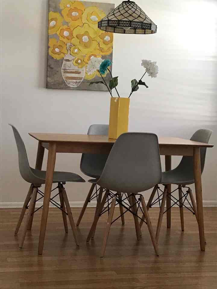 Brightening up the dining table with this beautiful yellow vase! 🍋💛 It perfectly complements the vibrant painting and adds a cheerful touch to the space. #HomeDecor #ArtAndStyle #YellowVibes #DiningTable #MidCenturyModern #EamesChairs
